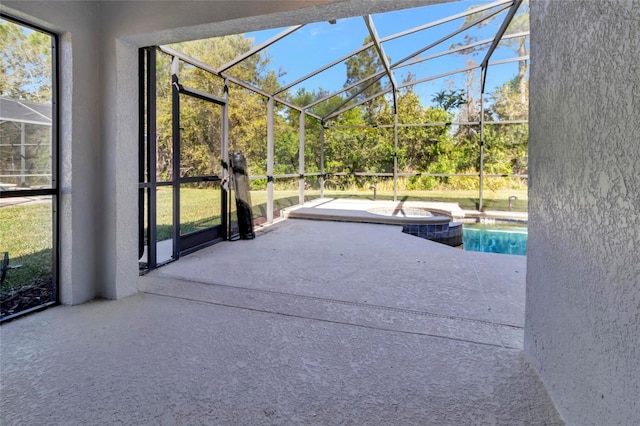 unfurnished sunroom featuring a jacuzzi