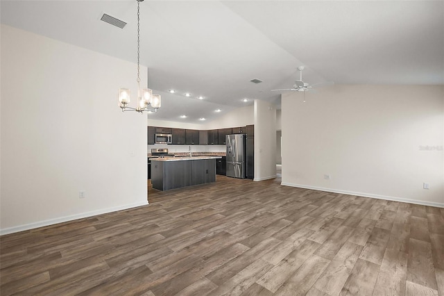 3557 Cochran St, The Villages, FL 32163 - kitchen featuring visible vents, light countertops, lofted ceiling, stainless steel appliances, and open floor plan