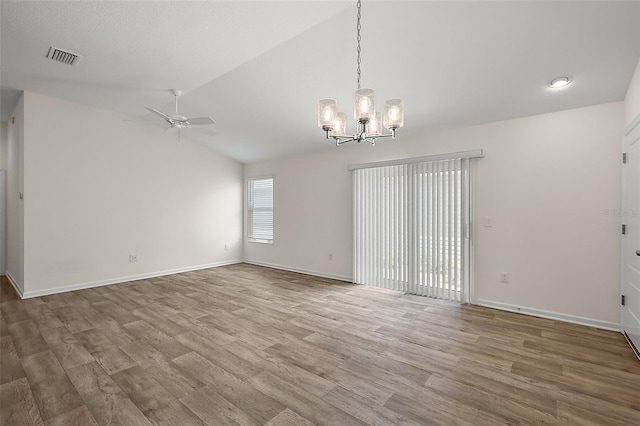 3557 Cochran St, The Villages, FL 32163 - spare room with lofted ceiling, ceiling fan with notable chandelier, baseboards, and wood finished floors