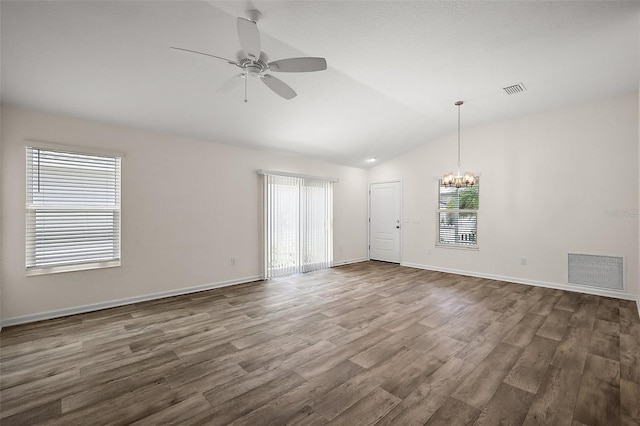 3557 Cochran St, The Villages, FL 32163 - empty room with ceiling fan with notable chandelier, dark wood-style flooring, lofted ceiling, and visible vents