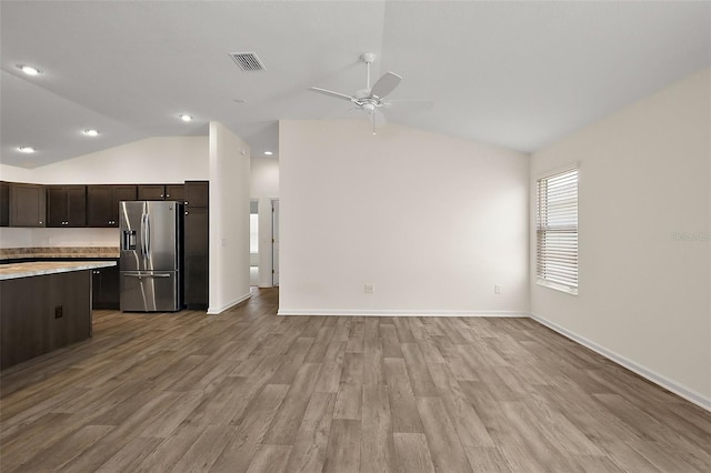 3557 Cochran St, The Villages, FL 32163 - unfurnished living room with visible vents, light wood-type flooring, a ceiling fan, and lofted ceiling