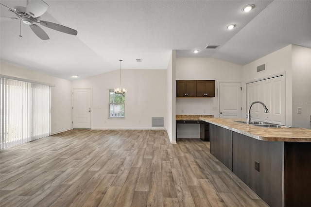 3557 Cochran St, The Villages, FL 32163 - kitchen featuring butcher block counters, visible vents, a sink, and vaulted ceiling