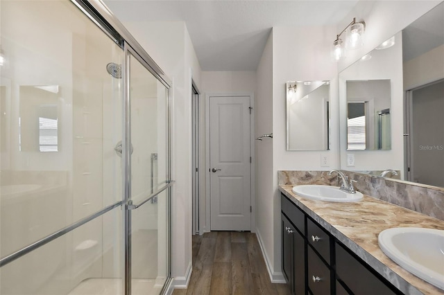 3557 Cochran St, The Villages, FL 32163 - full bath with double vanity, a sink, a stall shower, and wood finished floors