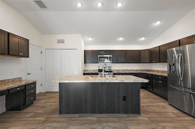 3557 Cochran St, The Villages, FL 32163 - kitchen featuring lofted ceiling, appliances with stainless steel finishes, a sink, and light countertops