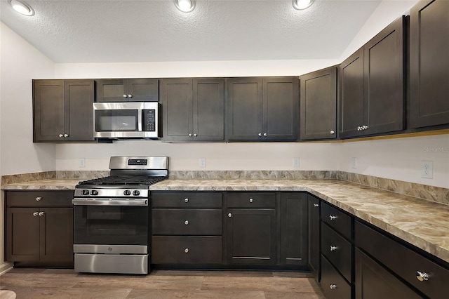 3557 Cochran St, The Villages, FL 32163 - kitchen featuring light countertops, stainless steel appliances, light wood finished floors, and a textured ceiling