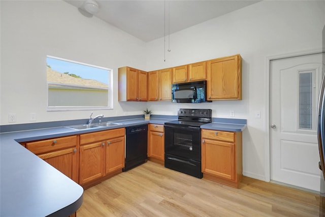 2433 Tamarindo Dr, The Villages, FL 32162 - kitchen with brown cabinets, black appliances, light wood-style flooring, and a sink