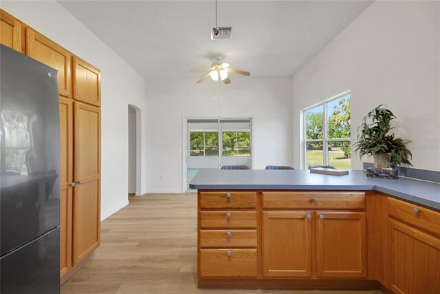 2433 Tamarindo Dr, The Villages, FL 32162 - kitchen featuring a ceiling fan, freestanding refrigerator, plenty of natural light, visible vents, and arched walkways