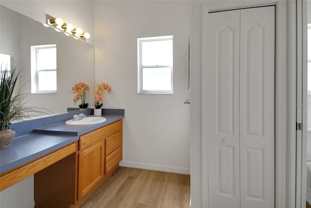 2433 Tamarindo Dr, The Villages, FL 32162 - bathroom with wood finished floors, a closet, toilet, and a healthy amount of sunlight