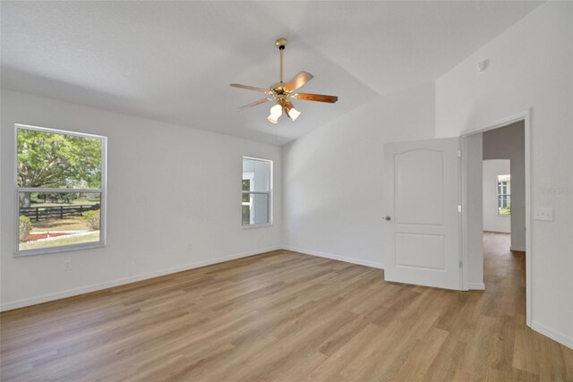 2433 Tamarindo Dr, The Villages, FL 32162 - empty room with baseboards, ceiling fan, light wood-style flooring, and vaulted ceiling
