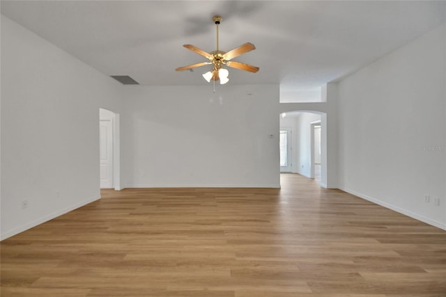 2433 Tamarindo Dr, The Villages, FL 32162 - unfurnished room featuring baseboards, arched walkways, light wood finished floors, visible vents, and ceiling fan