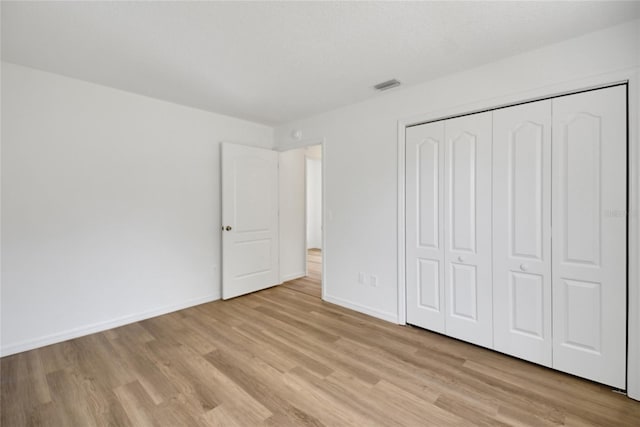 2433 Tamarindo Dr, The Villages, FL 32162 - unfurnished bedroom featuring baseboards, visible vents, a closet, and light wood-style flooring