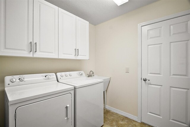 1093 Peninsula St, The Villages, FL 32162 - washroom with separate washer and dryer, baseboards, cabinet space, and a textured ceiling