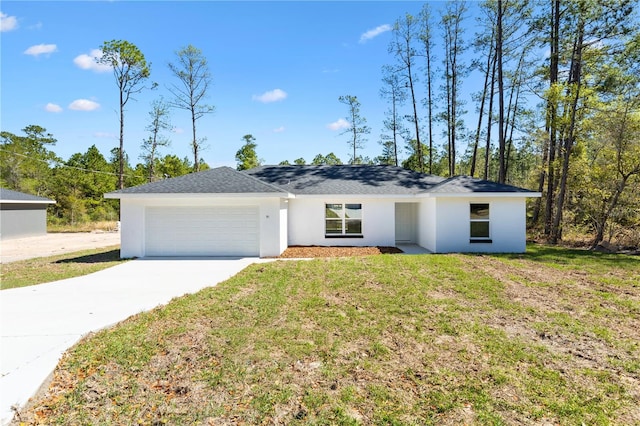 view of front of home featuring concrete driveway, an attached garage, a front yard, and stucco siding