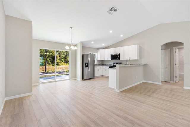 kitchen with visible vents, arched walkways, appliances with stainless steel finishes, a notable chandelier, and light wood-type flooring