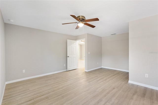 spare room featuring visible vents, baseboards, light wood-type flooring, and a ceiling fan
