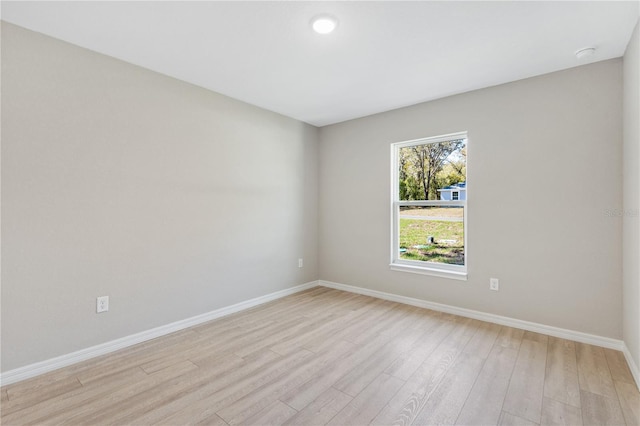 empty room with light wood-style flooring and baseboards