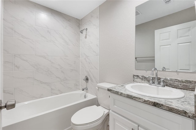 full bathroom featuring vanity, visible vents, shower / bathing tub combination, toilet, and a textured wall
