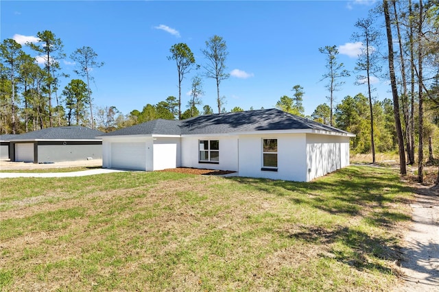 view of front facade with a front lawn, concrete driveway, a garage, and stucco siding