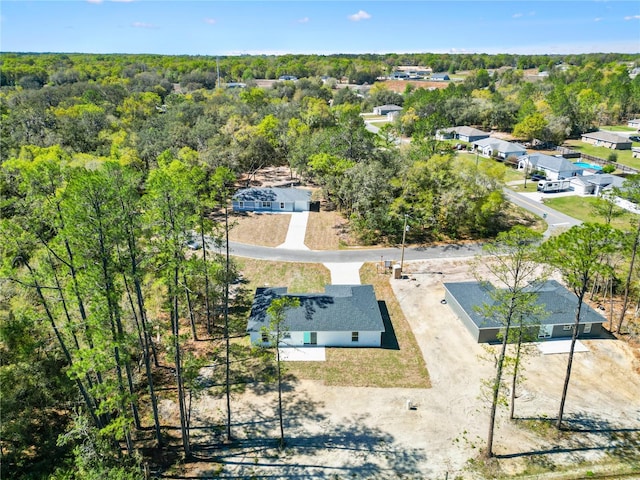 bird's eye view featuring a wooded view