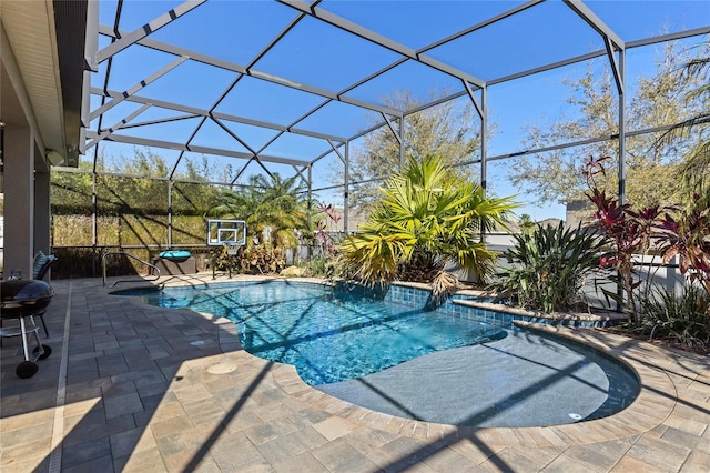 outdoor pool featuring glass enclosure and a patio area