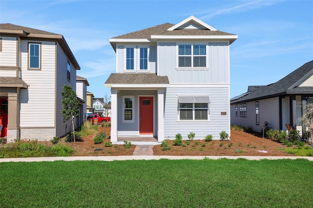 view of front of home featuring a front yard and board and batten siding