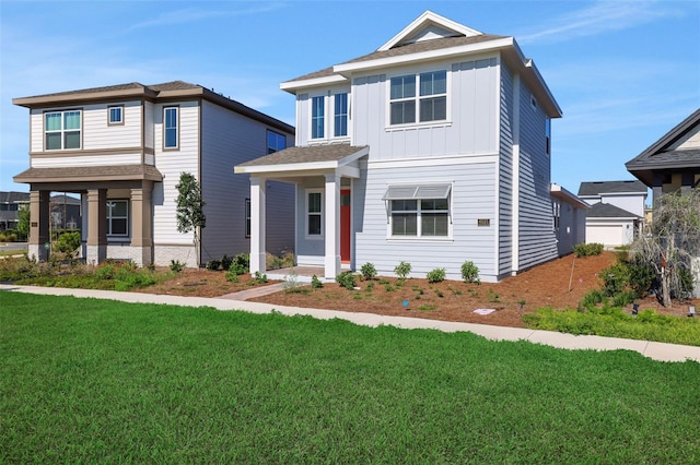 view of front facade with a front yard and board and batten siding