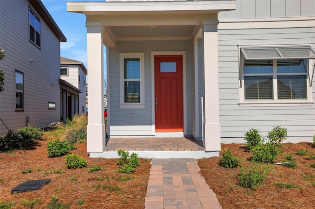 doorway to property featuring board and batten siding