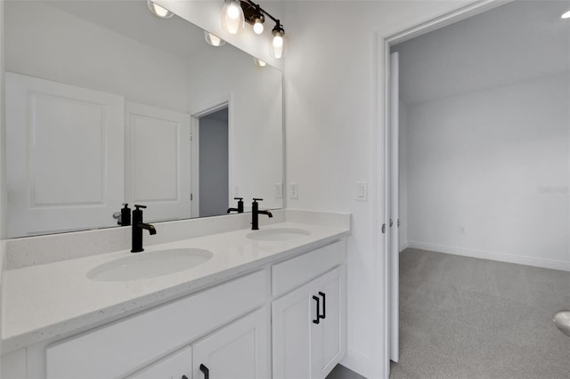 full bathroom featuring double vanity, baseboards, and a sink
