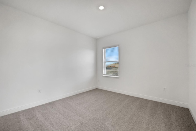 carpeted spare room with recessed lighting and baseboards