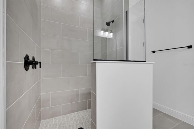 bathroom with baseboards and walk in shower