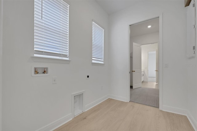 laundry area featuring baseboards, laundry area, hookup for a washing machine, light wood-style floors, and electric dryer hookup