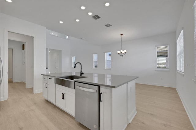 kitchen featuring a center island with sink, an inviting chandelier, a sink, white cabinets, and stainless steel dishwasher