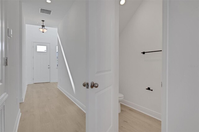 hall featuring recessed lighting, visible vents, baseboards, and light wood-style flooring