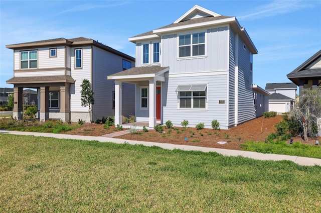 view of front of house with a front lawn and board and batten siding