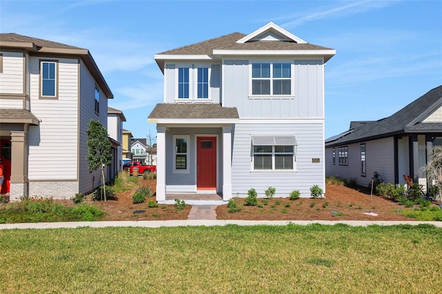 view of front of home with board and batten siding and a front lawn