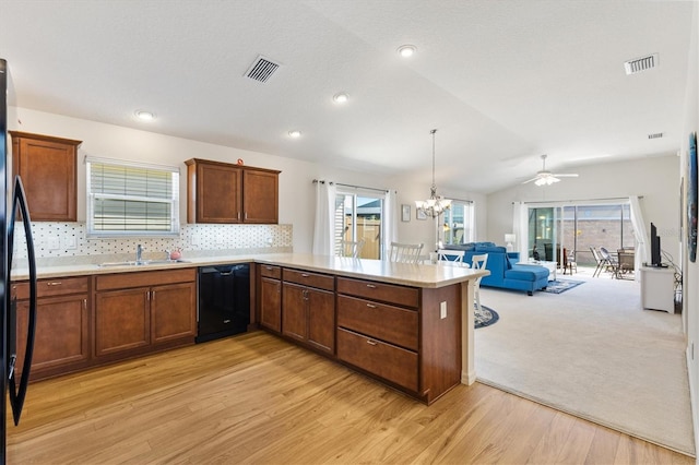 5829 Tupelo Ter, The Villages, FL 32163 - kitchen with black appliances, a sink, open floor plan, a peninsula, and light countertops