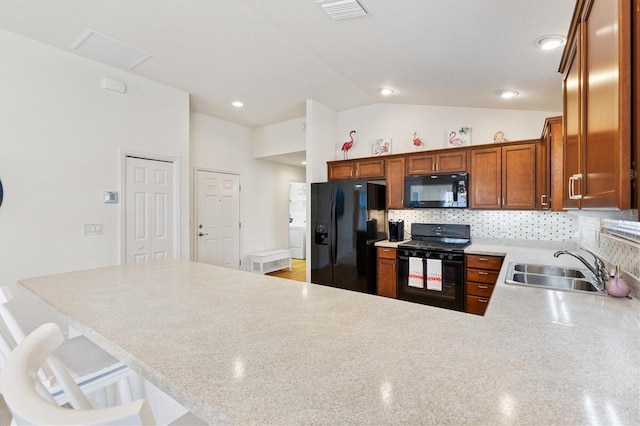 5829 Tupelo Ter, The Villages, FL 32163 - kitchen with black appliances, a sink, lofted ceiling, light countertops, and a peninsula