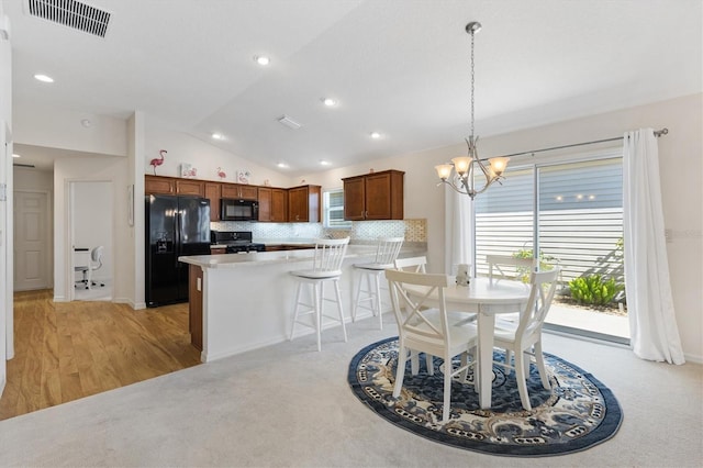 5829 Tupelo Ter, The Villages, FL 32163 - dining room with lofted ceiling, a chandelier, recessed lighting, and light colored carpet