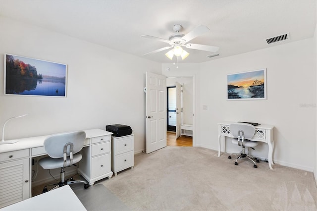 5829 Tupelo Ter, The Villages, FL 32163 - home office featuring a ceiling fan, light colored carpet, and baseboards