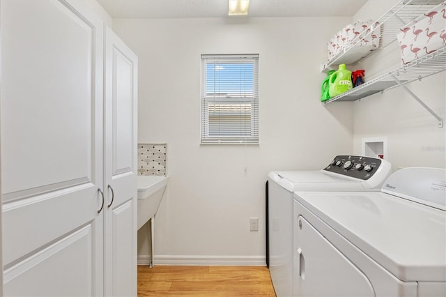 5829 Tupelo Ter, The Villages, FL 32163 - clothes washing area featuring washer and dryer, light wood-style flooring, and baseboards