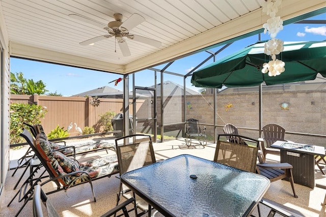 5829 Tupelo Ter, The Villages, FL 32163 - view of patio with outdoor dining space, a fenced backyard, ceiling fan, and glass enclosure