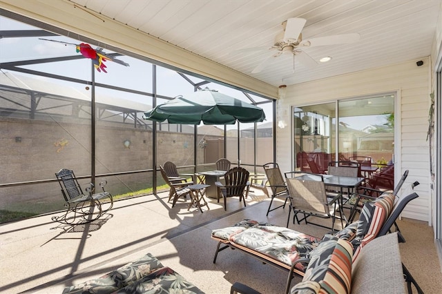 5829 Tupelo Ter, The Villages, FL 32163 - view of patio with outdoor dining area, a lanai, ceiling fan, and fence