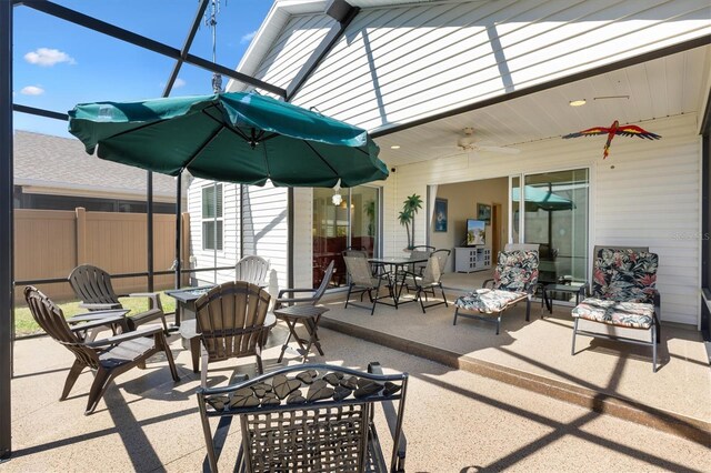 5829 Tupelo Ter, The Villages, FL 32163 - view of patio / terrace featuring outdoor dining area, a ceiling fan, glass enclosure, and fence