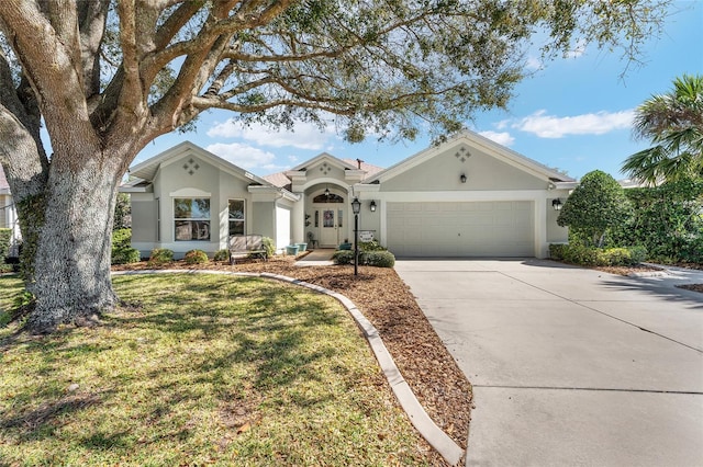 view of front of property featuring an attached garage, concrete driveway, stucco siding, and a front yard