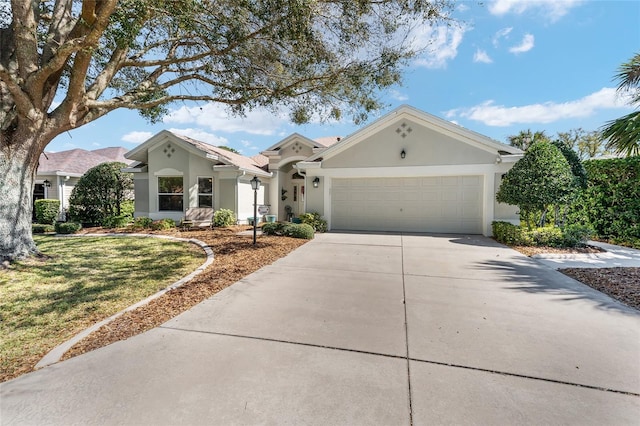 view of front of home with driveway, stucco siding, and an attached garage