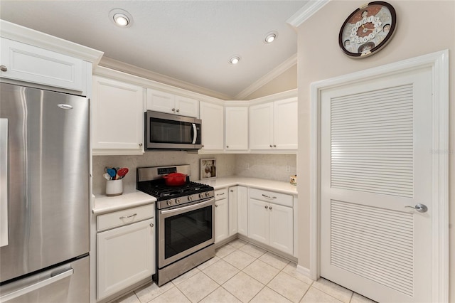 kitchen featuring stainless steel appliances, light countertops, crown molding, and light tile patterned flooring