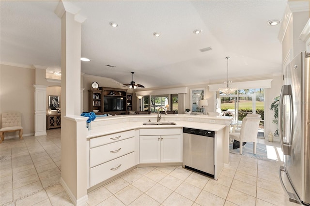 kitchen featuring a sink, open floor plan, crown molding, and stainless steel appliances