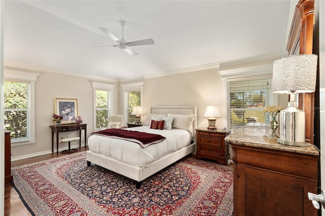 bedroom with crown molding, baseboards, a ceiling fan, and wood finished floors
