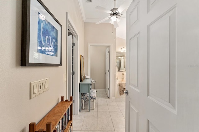 hall featuring light tile patterned floors, ornamental molding, and visible vents