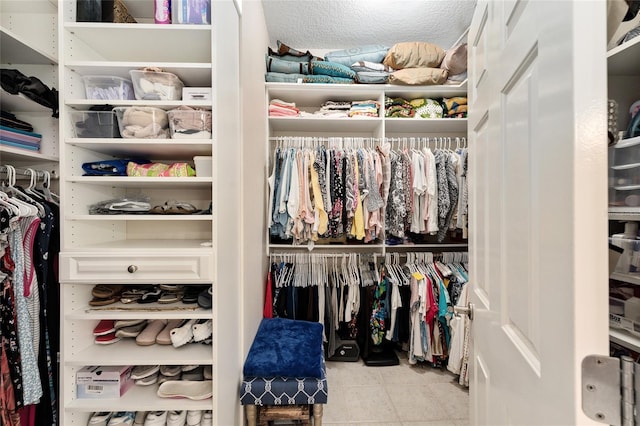 spacious closet with tile patterned floors